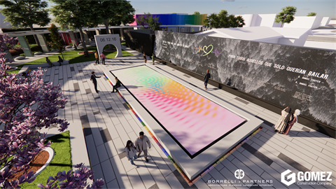 Aerial rendering of an outdoor memorial plaza featuring a long rectangular interactive surface with shifting rainbow colors. Visitors walk along wide stone pathways surrounded by trees, sculptures, and a large black wall engraved with text and artwork.