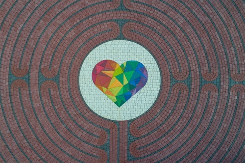 Aerial view of paved labyrinth. Colorful prismatic heart in the center